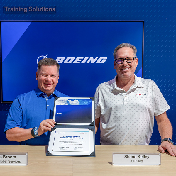 Shane Kelley and Chris Broom commemorating the Boeing and ATP JETS training agreement at EAA AirVenture Oshkosh