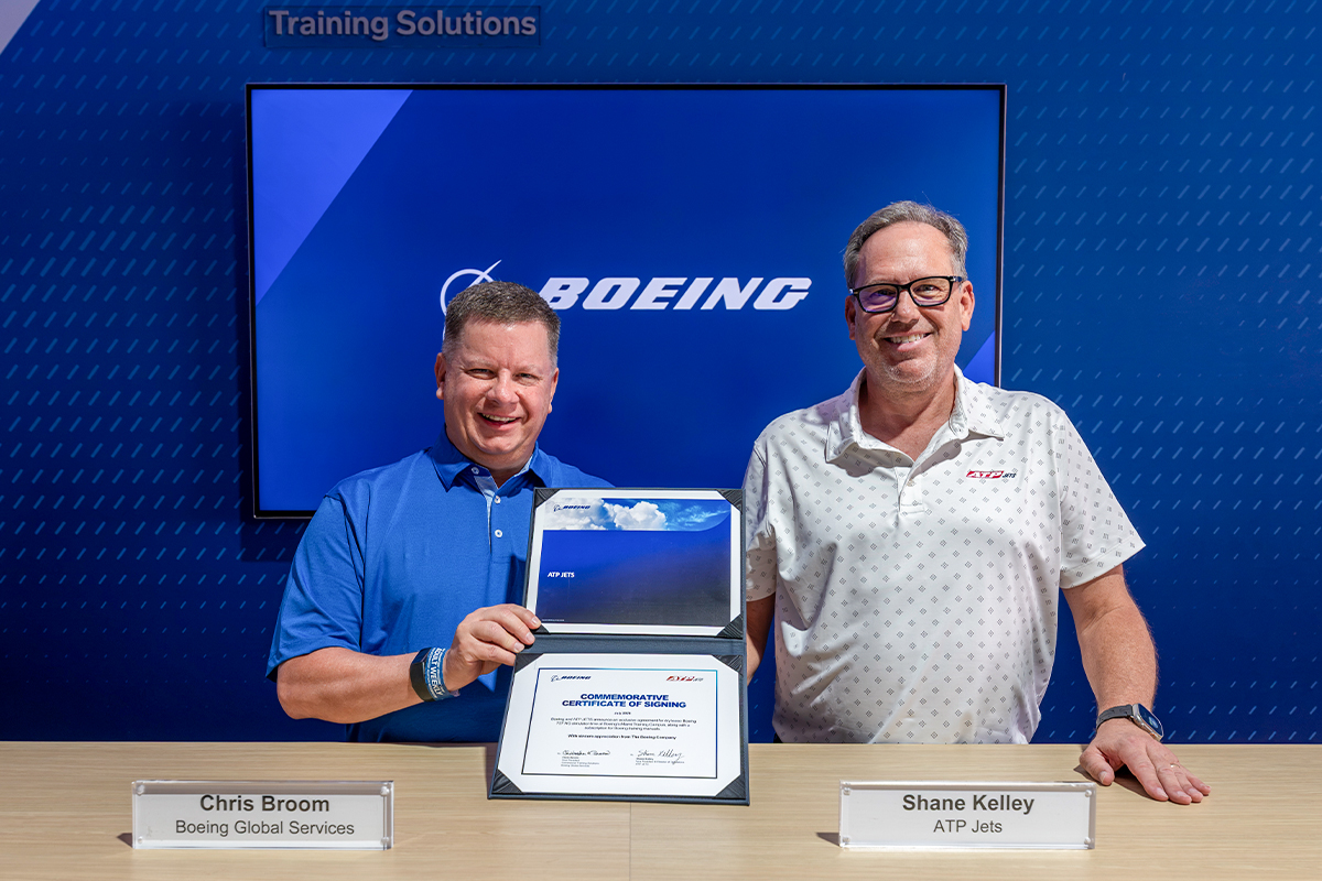 Shane Kelley and Chris Broom commemorating the Boeing and ATP JETS training agreement at EAA AirVenture Oshkosh